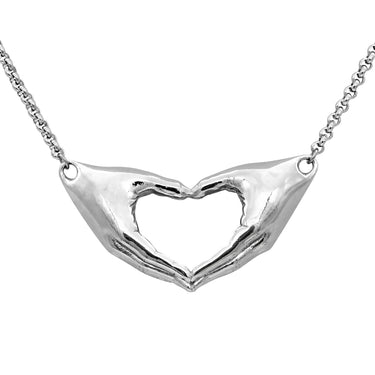 hands making a heart pendant necklace